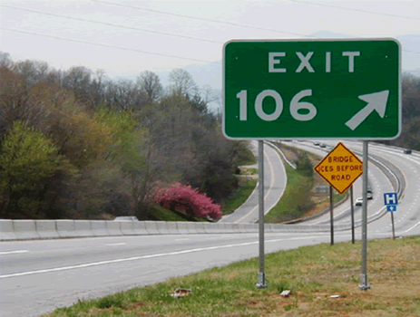 Exit 106 exit ramp sign with break-away posts